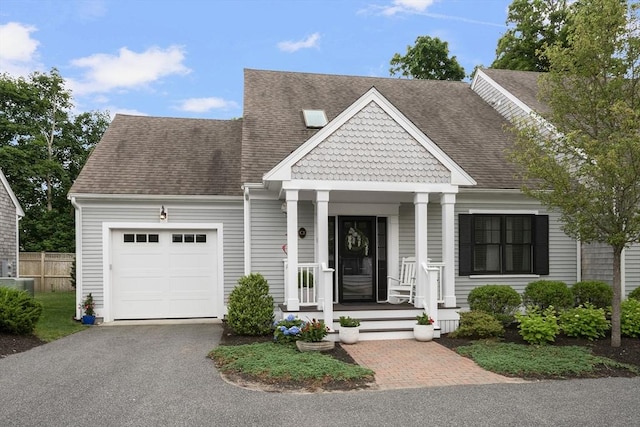 675 Main St Unit C1, Barnstable, MA 02635 - view of front of home with a garage, asphalt driveway, a porch, and a shingled roof