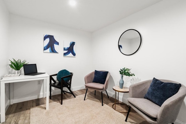 office space with wood finished floors and baseboards