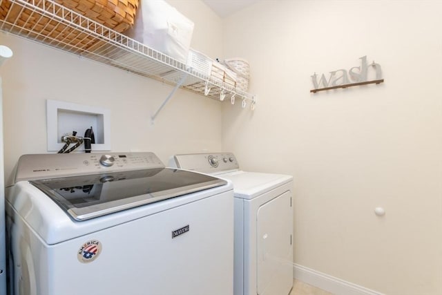 laundry room featuring laundry area, independent washer and dryer, and baseboards