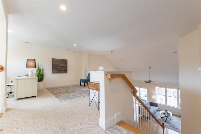 corridor featuring carpet, baseboards, lofted ceiling, recessed lighting, and an upstairs landing