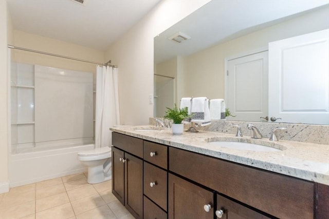 full bath featuring tile patterned floors, toilet, shower / bath combo with shower curtain, and a sink