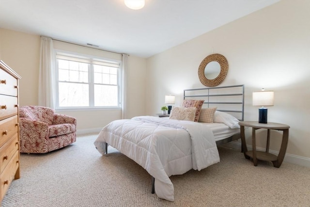 carpeted bedroom featuring visible vents and baseboards