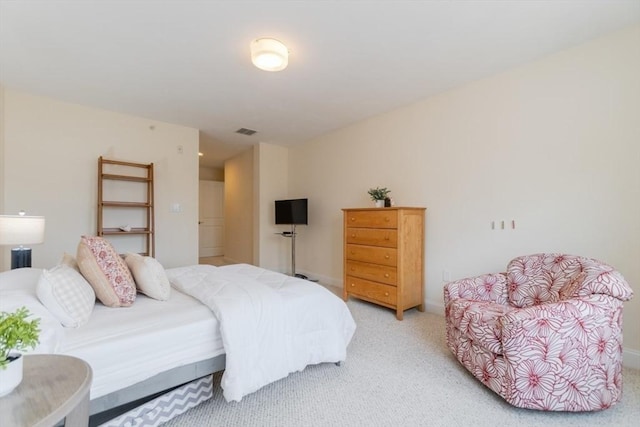 bedroom with light carpet, visible vents, and baseboards