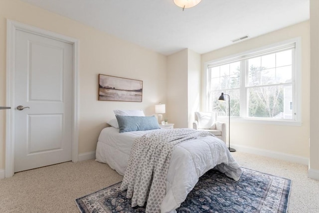 bedroom featuring visible vents, carpet, and baseboards