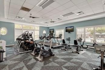 gym featuring a drop ceiling, visible vents, and baseboards