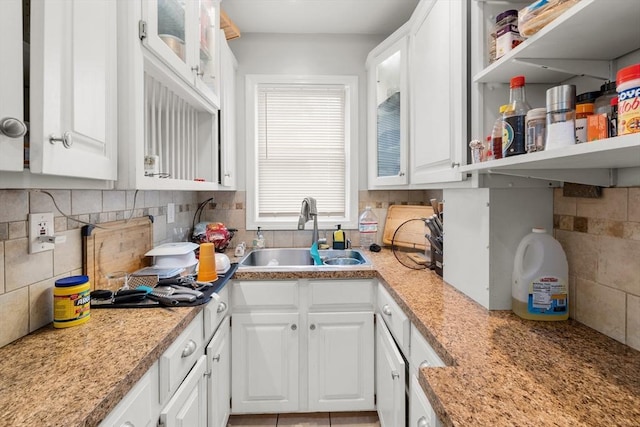 843 Stafford Rd, Fall River, MA 02721 - kitchen featuring white cabinetry, light countertops, tasteful backsplash, and glass insert cabinets