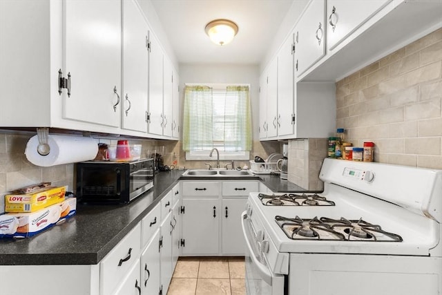 843 Stafford Rd, Fall River, MA 02721 - kitchen with white range with gas cooktop, black microwave, and white cabinets