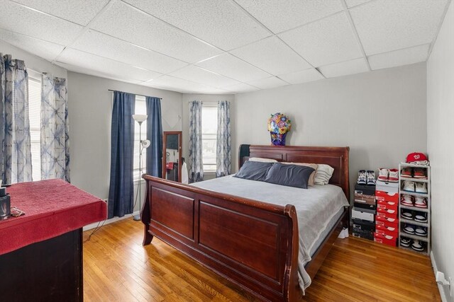 843 Stafford Rd, Fall River, MA 02721 - bedroom with a paneled ceiling, light wood finished floors, and multiple windows