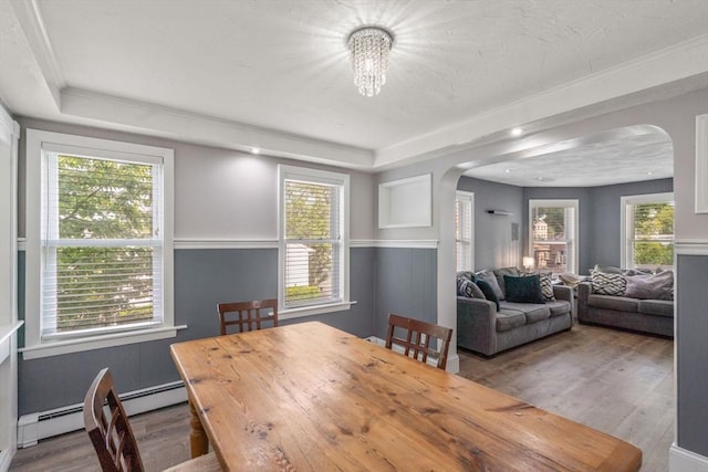 5 Ethel St, Blackstone, MA 01504 - dining room with arched walkways, wood finished floors, a tray ceiling, baseboard heating, and crown molding