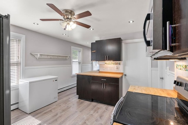 5 Ethel St, Blackstone, MA 01504 - kitchen with stainless steel appliances, baseboard heating, a wainscoted wall, wooden counters, and ceiling fan