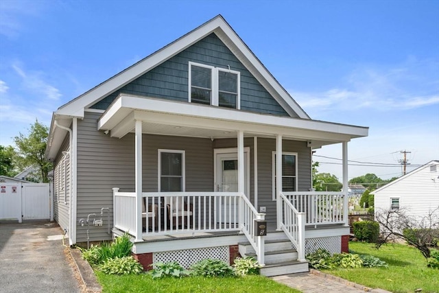 5 Ethel St, Blackstone, MA 01504 - view of front facade with covered porch, asphalt driveway, and a gate