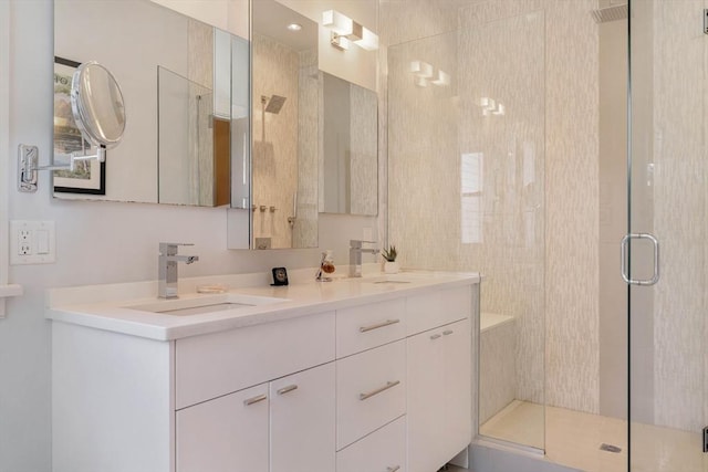 full bath featuring a shower stall, double vanity, and a sink