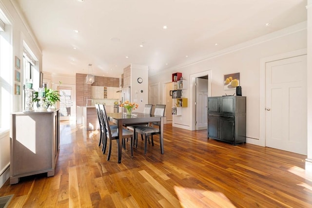 dining space featuring recessed lighting, visible vents, wood finished floors, and ornamental molding