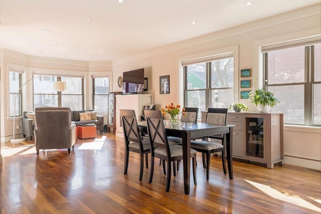 dining space featuring crown molding, recessed lighting, and wood finished floors