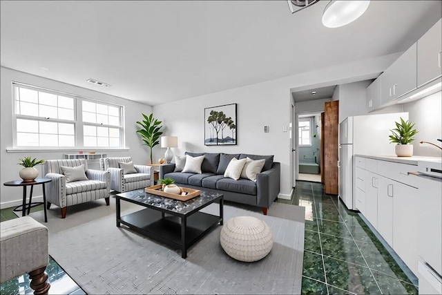 living area with dark marble finish floors and baseboards
