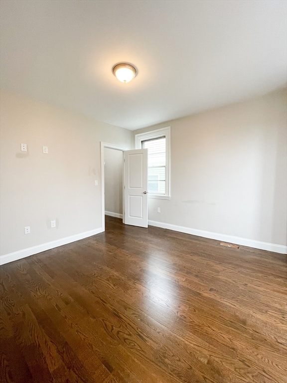 empty room featuring dark hardwood / wood-style flooring