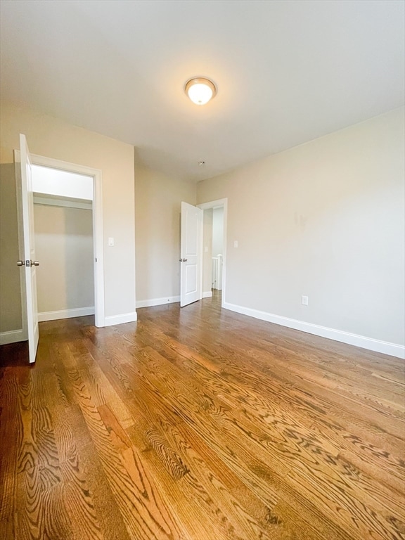 unfurnished bedroom with hardwood / wood-style floors