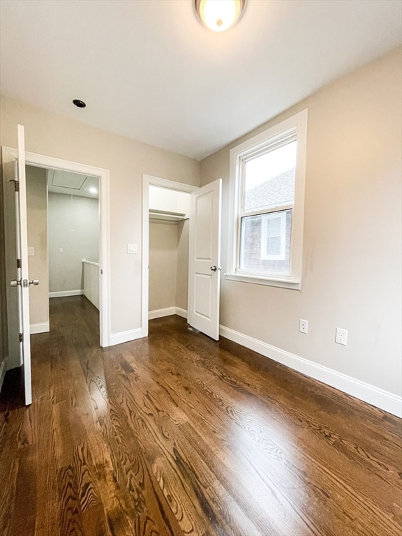 unfurnished bedroom featuring dark hardwood / wood-style flooring