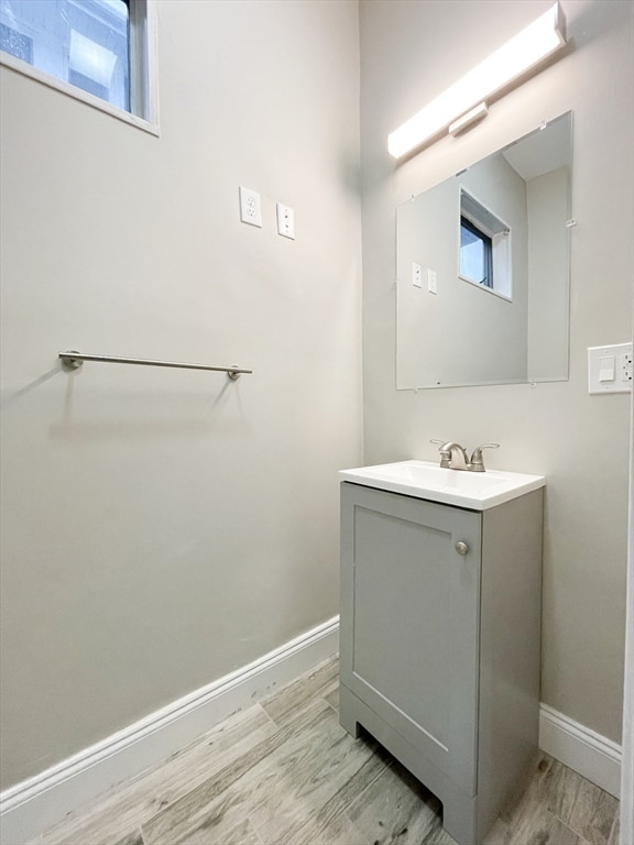 bathroom with vanity and hardwood / wood-style flooring