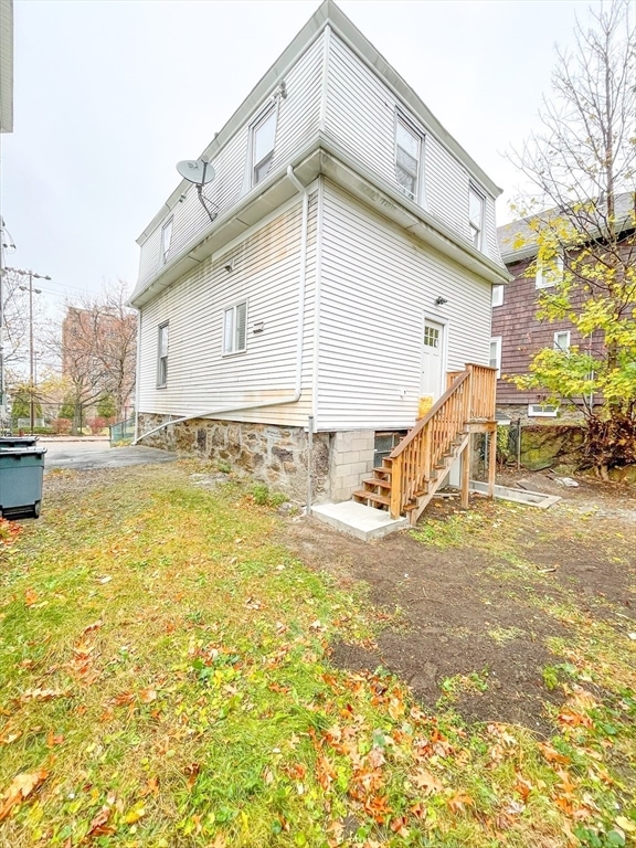 rear view of house with a lawn