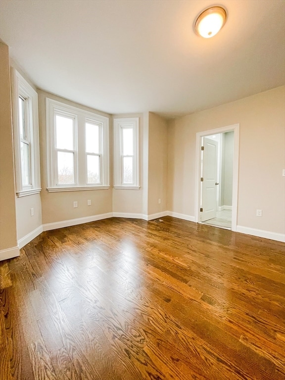 spare room featuring hardwood / wood-style floors