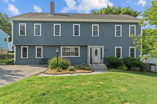 8 Lilian Rd, Framingham, MA 01701 - view of front facade featuring a chimney and a front lawn