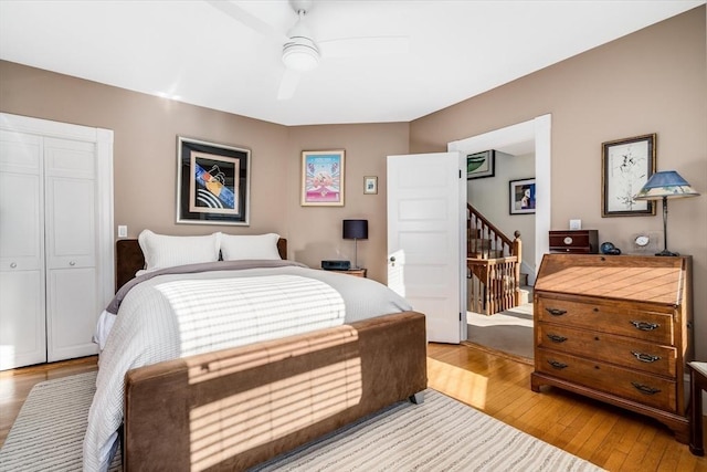 bedroom featuring ceiling fan, light hardwood / wood-style floors, and a closet