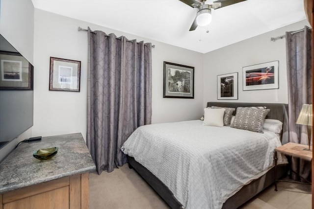 bedroom with ceiling fan and light carpet