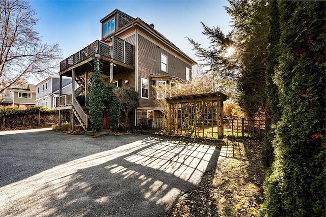 rear view of property featuring a balcony