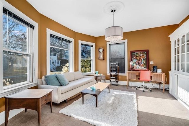 interior space featuring light colored carpet and a healthy amount of sunlight