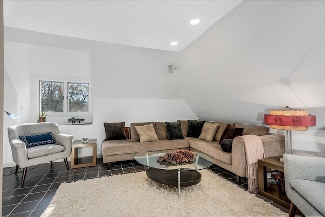 living room with dark tile patterned floors and lofted ceiling