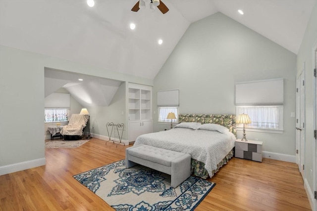 bedroom featuring hardwood / wood-style flooring, high vaulted ceiling, and ceiling fan