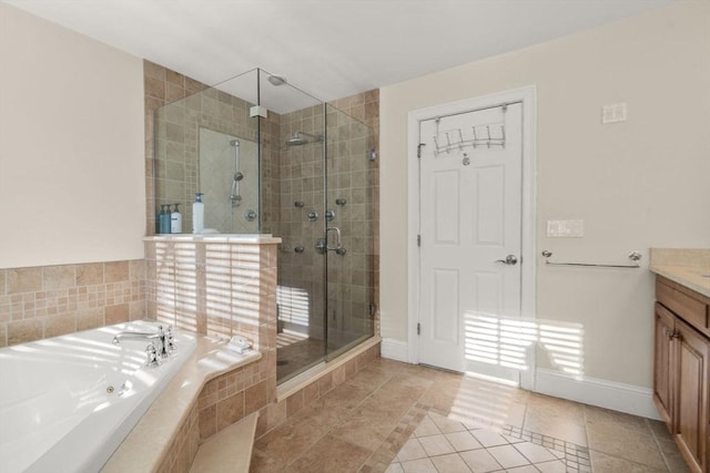 bathroom featuring shower with separate bathtub, vanity, and tile patterned flooring