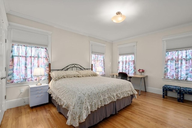 bedroom with ornamental molding and hardwood / wood-style flooring