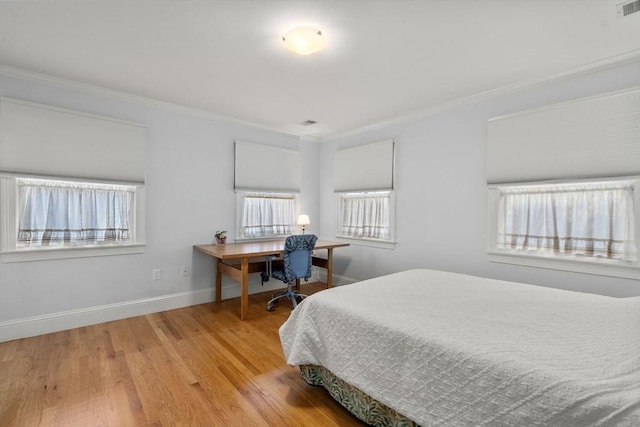 bedroom featuring ornamental molding and wood-type flooring