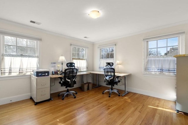 office area featuring light wood-type flooring, ornamental molding, and plenty of natural light