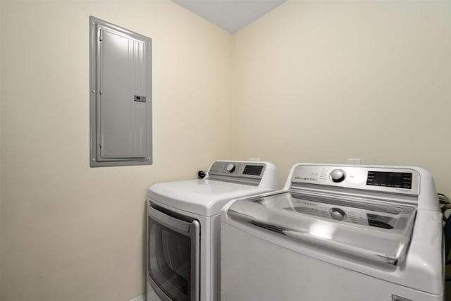 laundry room featuring electric panel and washer and dryer