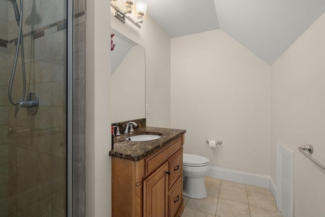 bathroom with lofted ceiling, tile patterned flooring, toilet, walk in shower, and vanity