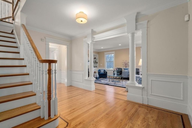 foyer entrance featuring light wood-type flooring and ornamental molding