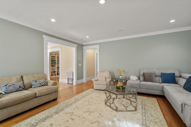 living room with hardwood / wood-style floors and ornamental molding