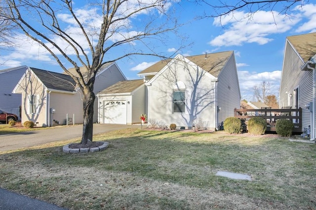 view of front of property featuring a wooden deck, a front lawn, and a garage