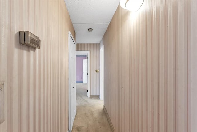 hallway with a textured ceiling