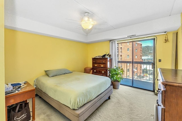 bedroom featuring a ceiling fan, access to exterior, light colored carpet, and visible vents