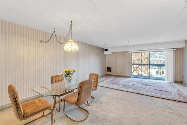 dining area featuring an inviting chandelier, baseboards, and visible vents