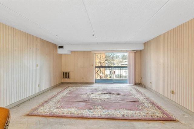 unfurnished room featuring visible vents and baseboards