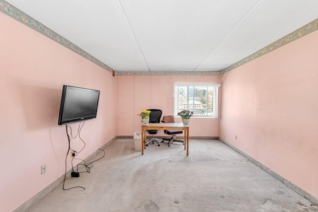 office space featuring baseboards and concrete floors