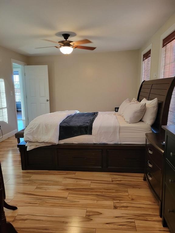 bedroom with ceiling fan and light hardwood / wood-style floors