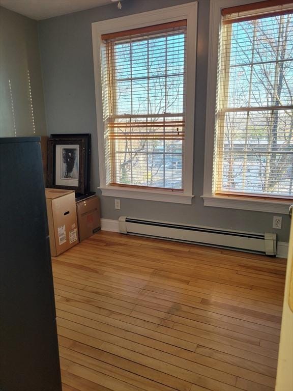 interior space featuring wood-type flooring and baseboard heating