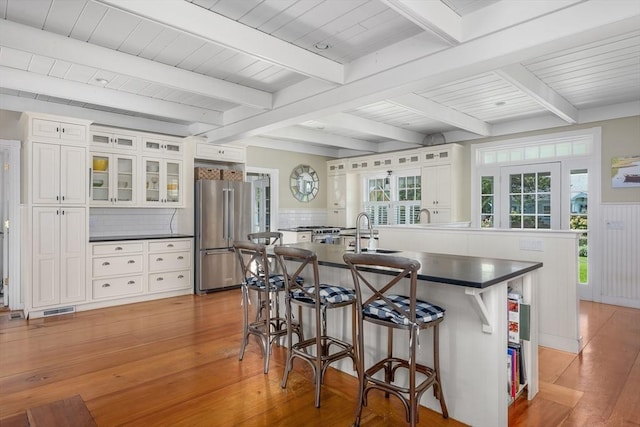 21 N Rd, Harwich, MA 02671 - kitchen featuring a kitchen breakfast bar, dark countertops, visible vents, freestanding refrigerator, and light wood-style floors