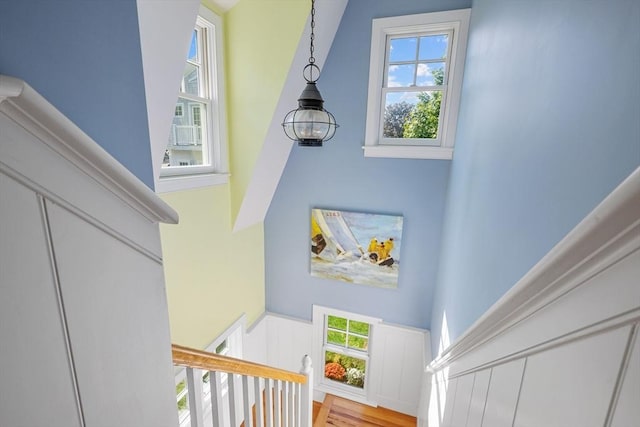 21 N Rd, Harwich, MA 02671 - staircase with a wealth of natural light, a wainscoted wall, a towering ceiling, and a decorative wall